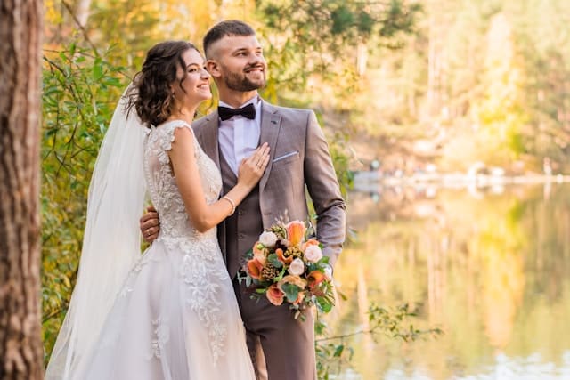 結婚 焦り 湖畔に佇むウェディングドレスを着た女性とタキシードの男性。